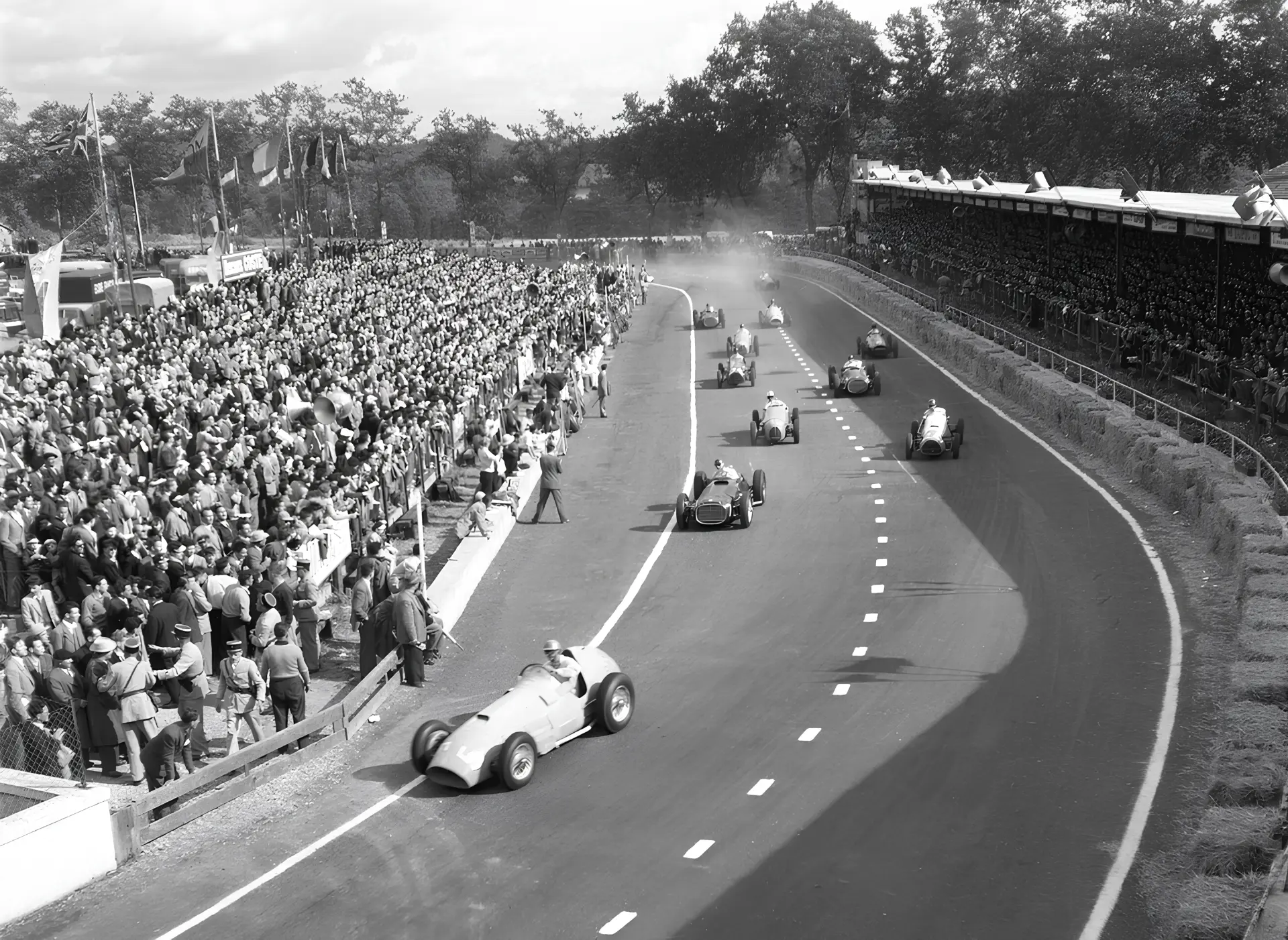 Grand Prix d'Albi 1953 — Louis Rosier sur Ferrari 375 suivi par Juan Manuel Fangio sur BRM, négociation d'un virage devant les tribunes
